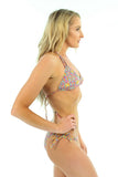Side of tan through string bikini bottom with double tie sides in orange Bubbles.