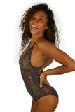 Side of V neck adjustable criss cross strap swimsuit in tan through multicolor Safari fabric.