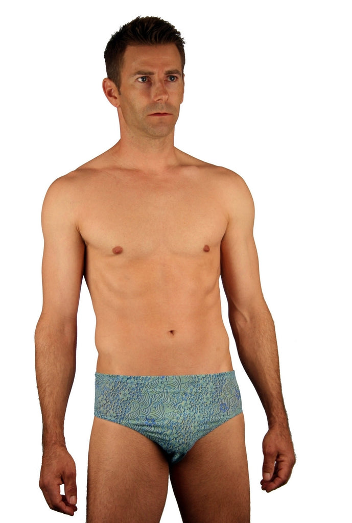 Blue Floral Wave tan through men's swimsuit racer with 3 inch side.