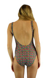 Back view of tan through traditional tank swimsuit in pink Toucan print.