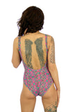 Nicole modeling back of Kaleidoscope underwire support swimsuit with C-D cups.