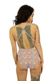 Orange Bubbles tan through womens swimwear with criss cross adjustable straps -- back view.