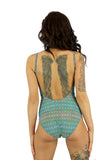 Back view of tan through women's swimsuit in green Forever print with adjustable straps and underwire support.